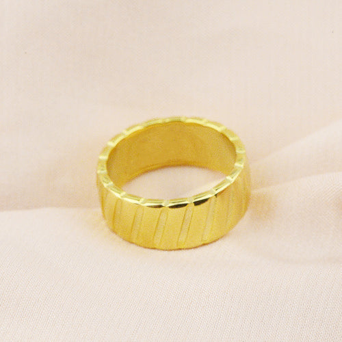 Bague en acier titane avec motif biseauté en or 18 carats, élégante et moderne, portée sur le doigt.