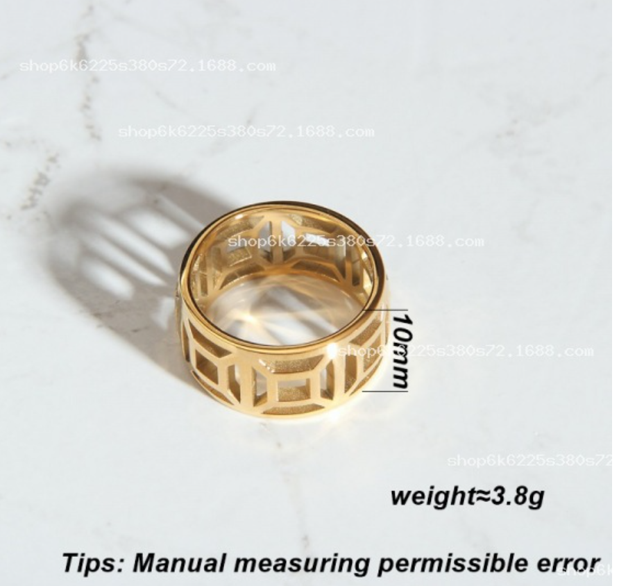 Bague en acier titane plaqué or avec motif en grille creuse, élégante et moderne, portée sur le doigt.
