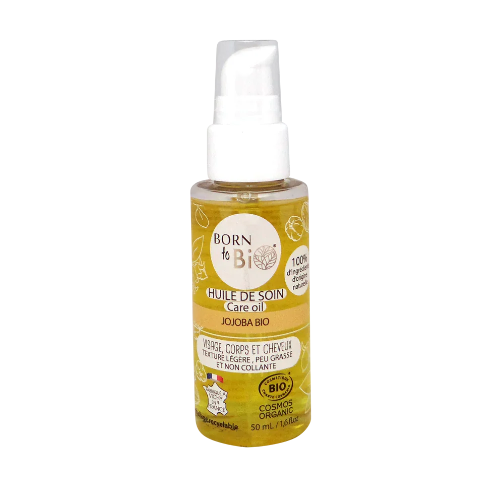 Huile de soin bio à base de jojoba de la marque Born to Bio, flacon transparent montrant la texture claire de l'huile